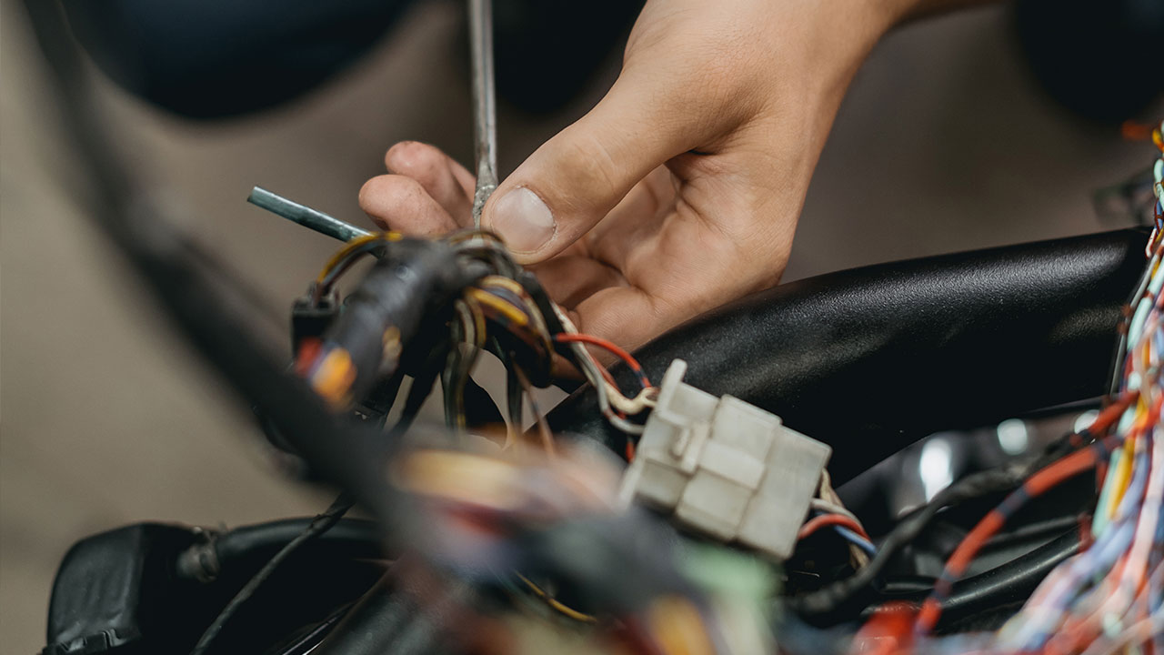 hand with screw driver fixing automotive connector